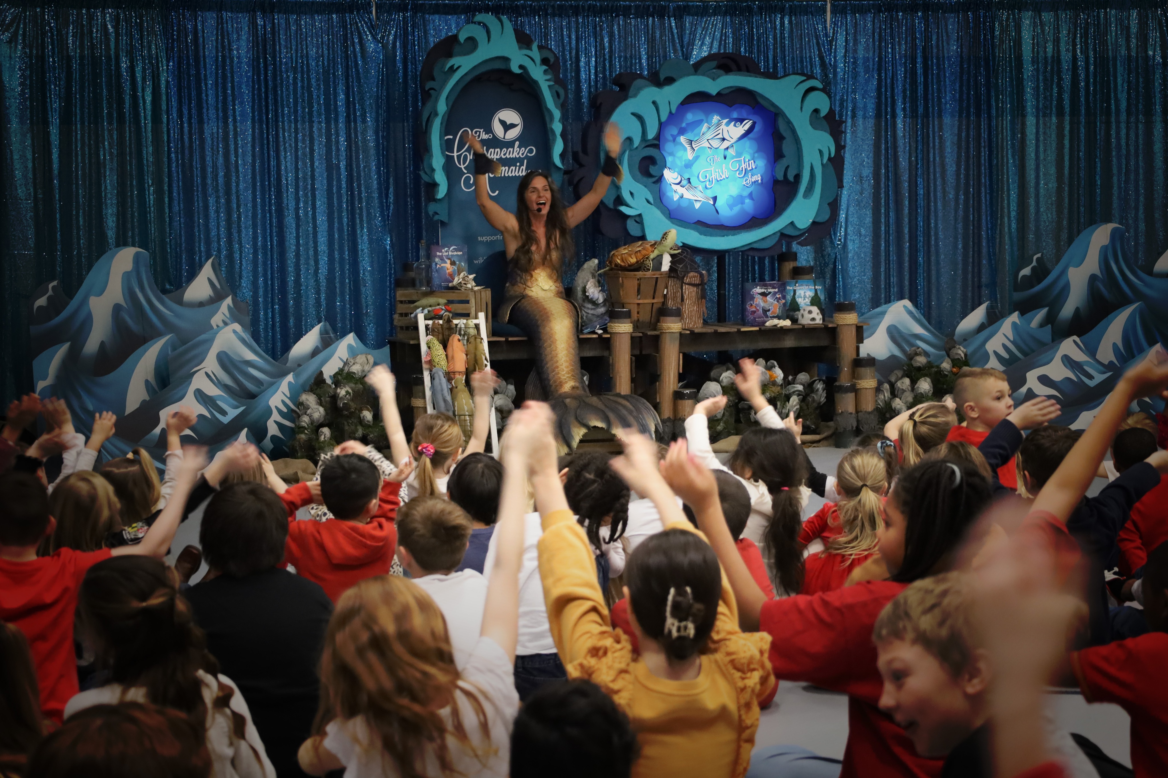 The Chesapeake Mermaid performing an educational show for students at Deal Island Elementary